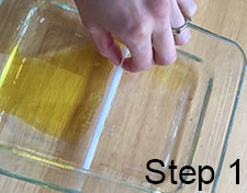 pushing oil across water with straw