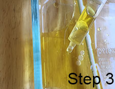 sucking up oil with syringe